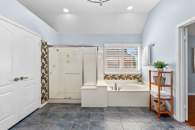 bathroom featuring tile patterned flooring, independent shower and bath, and vaulted ceiling