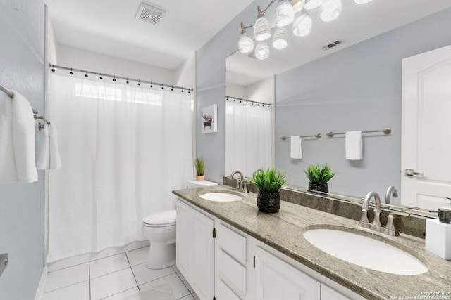 bathroom with tile patterned flooring, vanity, and toilet