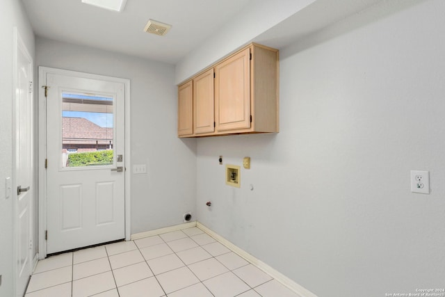 clothes washing area with cabinets, electric dryer hookup, hookup for a gas dryer, hookup for a washing machine, and light tile patterned floors