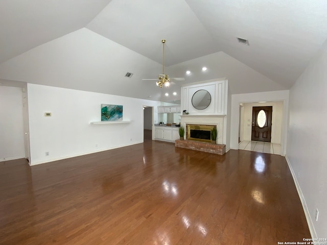 unfurnished living room with ceiling fan, a fireplace, light hardwood / wood-style floors, and lofted ceiling