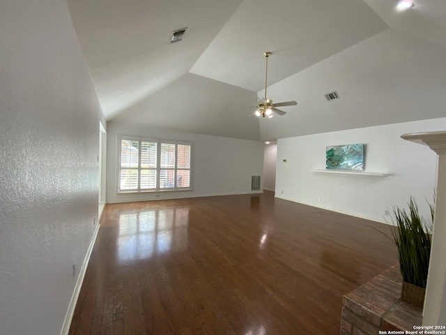 unfurnished living room featuring dark hardwood / wood-style floors, ceiling fan, and vaulted ceiling