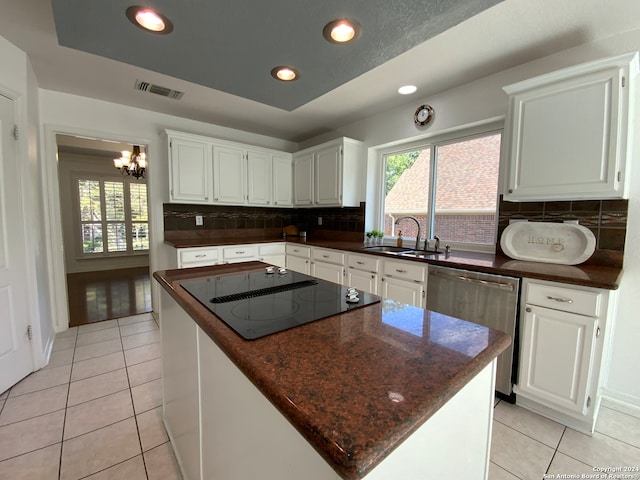 kitchen with backsplash, white cabinetry, a center island, and a healthy amount of sunlight