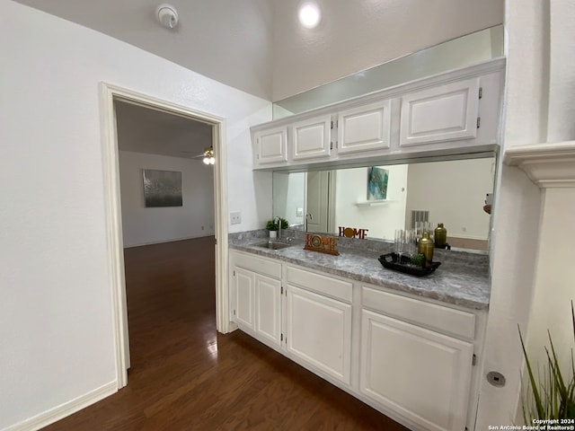 kitchen featuring white cabinets, dark hardwood / wood-style floors, ceiling fan, and sink