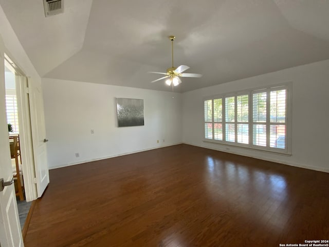 unfurnished living room featuring ceiling fan and dark wood-type flooring