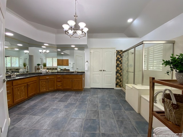 bathroom with tile patterned floors, vanity, vaulted ceiling, an inviting chandelier, and a shower with shower door