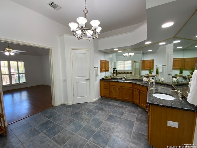 bathroom featuring hardwood / wood-style floors, ceiling fan with notable chandelier, and vanity