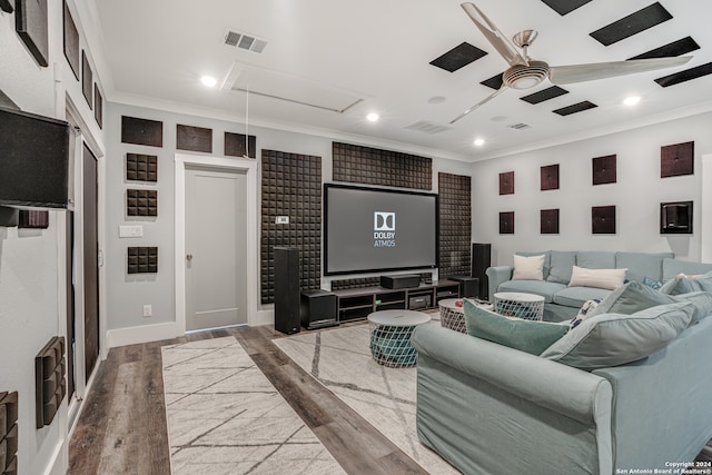 cinema featuring hardwood / wood-style floors, ceiling fan, and ornamental molding