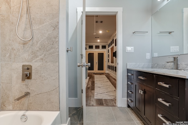 bathroom with hardwood / wood-style floors, vanity, and  shower combination