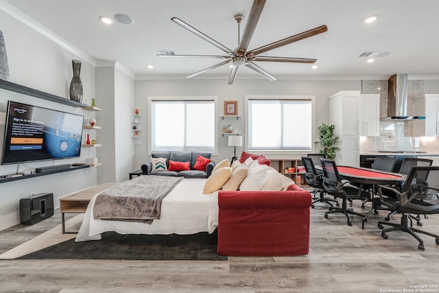 bedroom with ceiling fan, light hardwood / wood-style floors, and ornamental molding