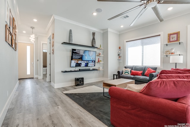 living room featuring light wood-type flooring, ceiling fan, and ornamental molding