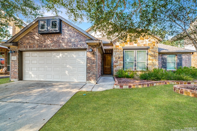 view of front of property with a front yard and a garage