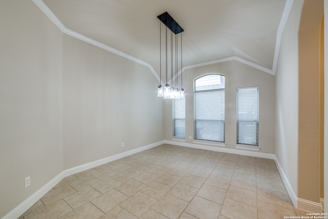 tiled spare room featuring a chandelier, lofted ceiling, and ornamental molding