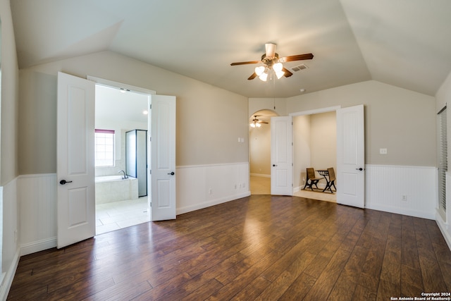 spare room featuring ceiling fan, dark hardwood / wood-style floors, and vaulted ceiling