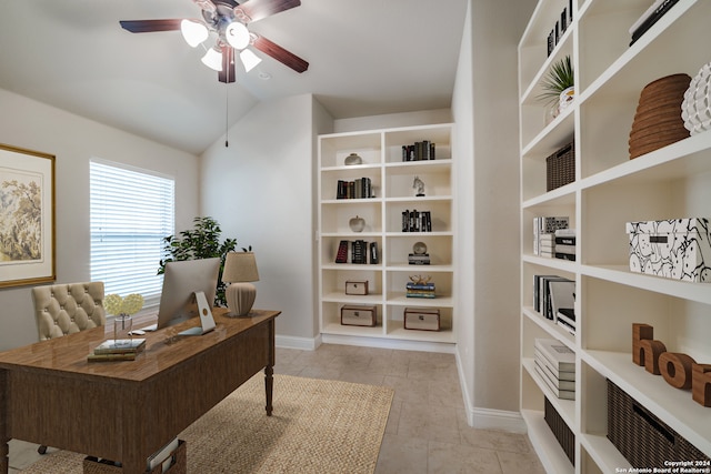 home office featuring ceiling fan, light tile patterned floors, and vaulted ceiling