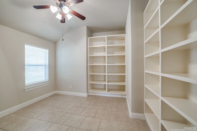 spacious closet featuring tile patterned flooring, vaulted ceiling, and ceiling fan