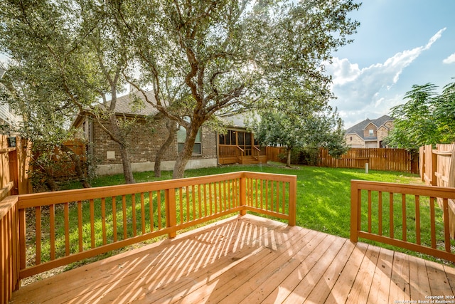 wooden deck with a lawn