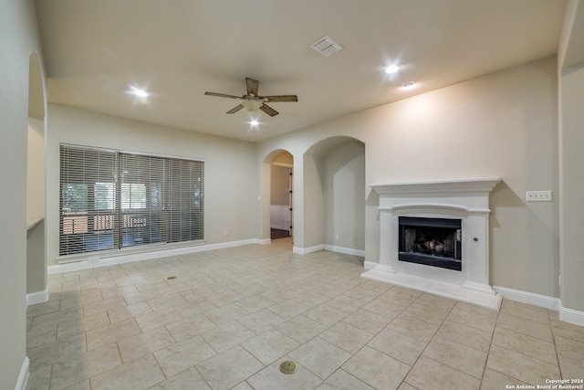 unfurnished living room with ceiling fan