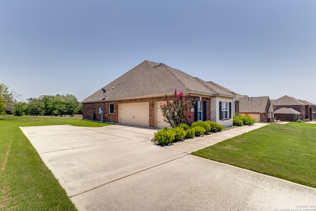 view of front of house with a front yard and a garage