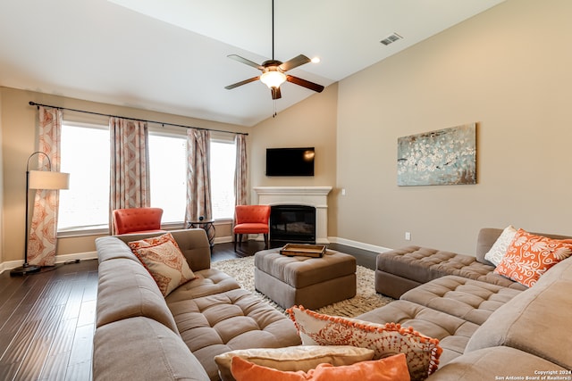 living room with dark hardwood / wood-style floors, vaulted ceiling, and ceiling fan