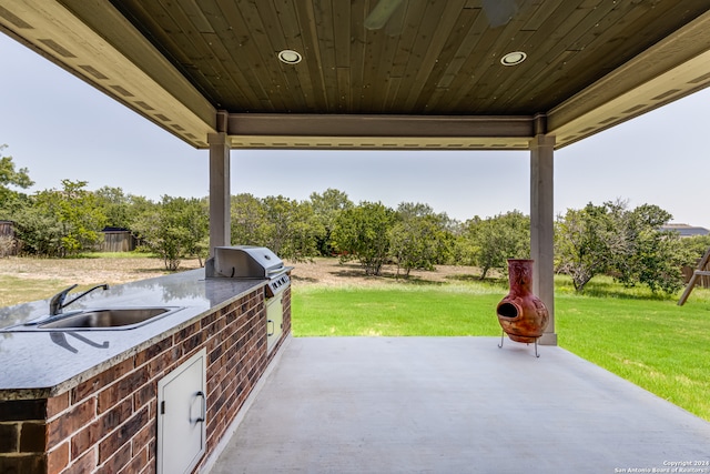 view of patio / terrace featuring grilling area, sink, and an outdoor kitchen