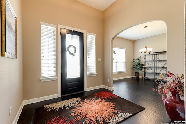 foyer entrance featuring a chandelier and dark hardwood / wood-style floors