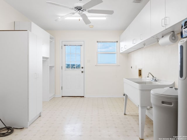 laundry area featuring ceiling fan, cabinets, and washer hookup