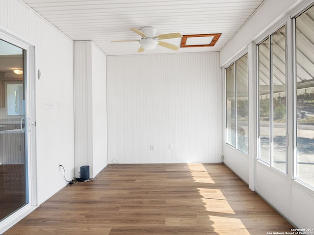 unfurnished sunroom featuring ceiling fan and wooden ceiling