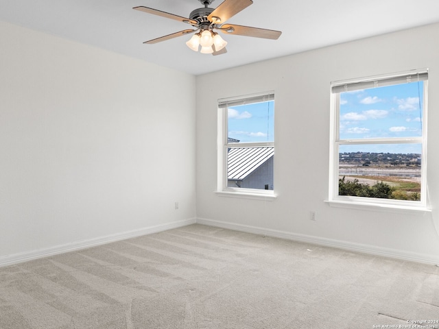 carpeted empty room with ceiling fan