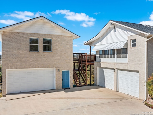 view of home's exterior with a deck and a garage