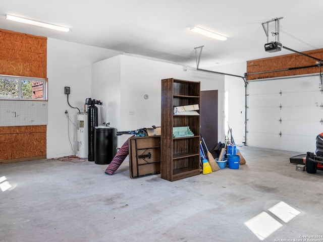 garage with electric water heater and a garage door opener