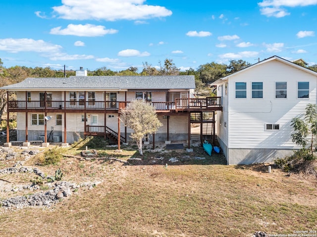 back of property featuring a yard and a wooden deck