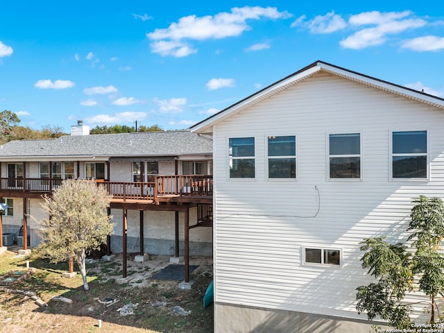 rear view of property featuring a deck