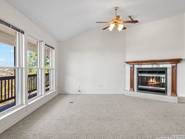 unfurnished living room with carpet, ceiling fan, and vaulted ceiling