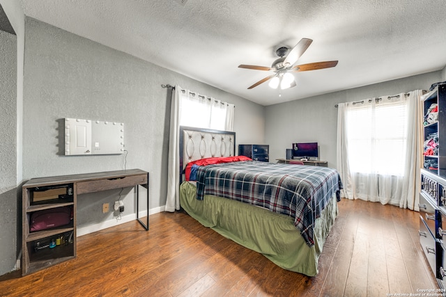 bedroom featuring a textured ceiling, hardwood / wood-style flooring, and ceiling fan