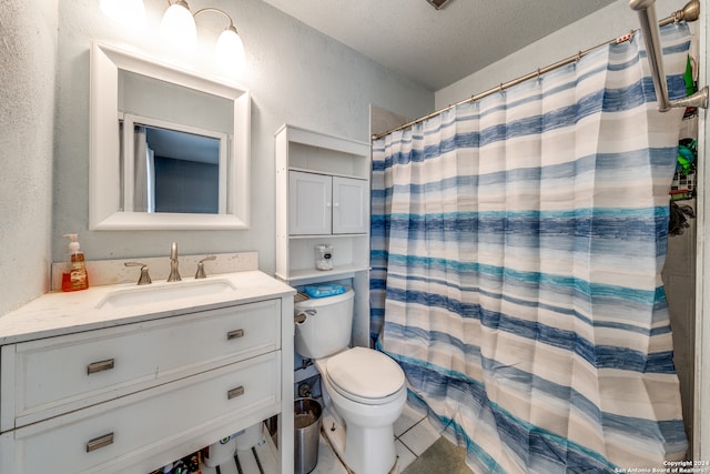 bathroom featuring vanity, a shower with curtain, tile patterned flooring, toilet, and a textured ceiling