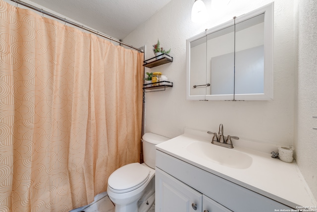 bathroom with vanity, a textured ceiling, and toilet