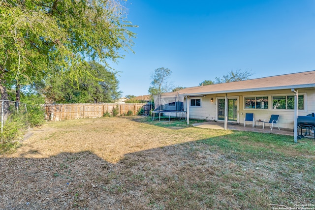 view of yard with a patio and a trampoline