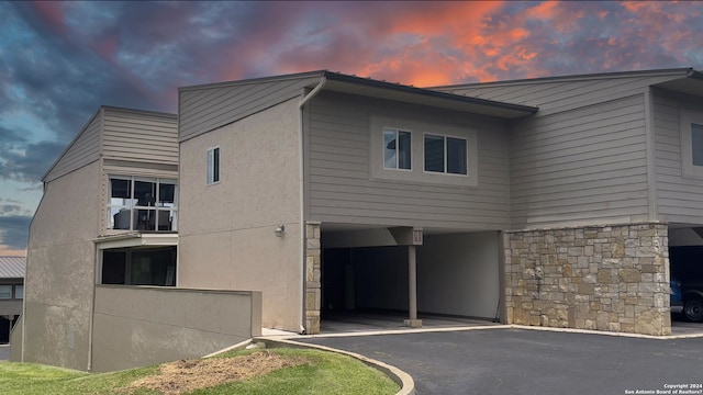 property exterior at dusk with a carport