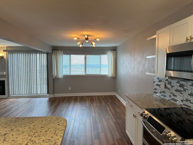 kitchen featuring dark wood-type flooring, white cabinets, decorative backsplash, light stone countertops, and appliances with stainless steel finishes