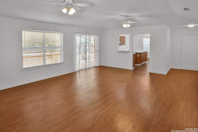 unfurnished living room featuring ceiling fan, plenty of natural light, and hardwood / wood-style flooring