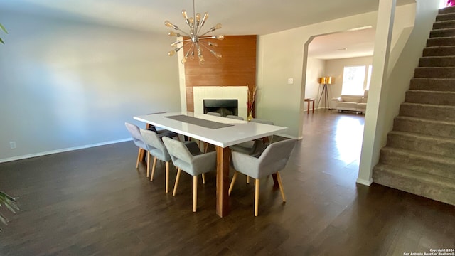 dining area featuring a notable chandelier and dark wood-type flooring