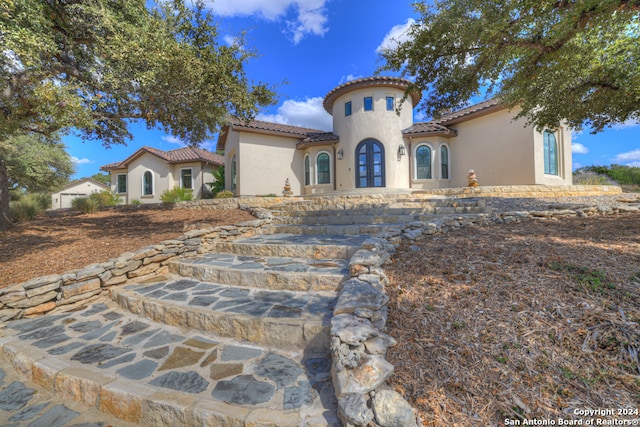 mediterranean / spanish house featuring french doors