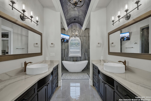 bathroom featuring a washtub, vanity, and a chandelier