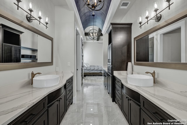 bathroom featuring vanity, an inviting chandelier, and ornamental molding