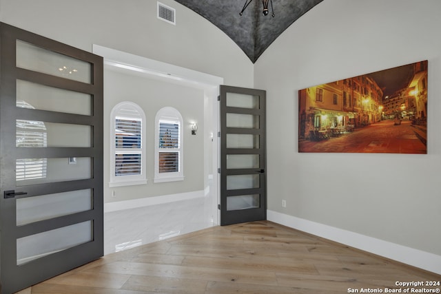 entryway with light hardwood / wood-style flooring and lofted ceiling