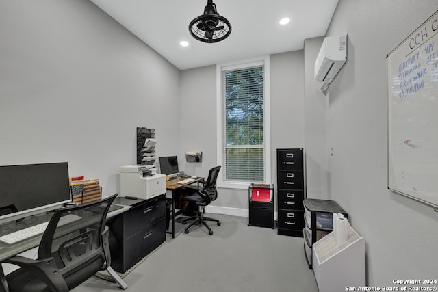 office area featuring an AC wall unit and concrete floors