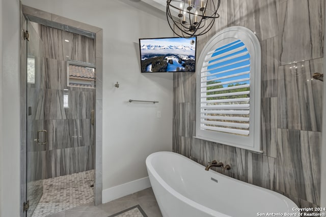 bathroom featuring tile patterned flooring and separate shower and tub