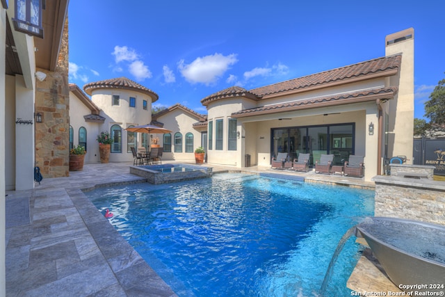 view of pool with an in ground hot tub, a patio, and ceiling fan