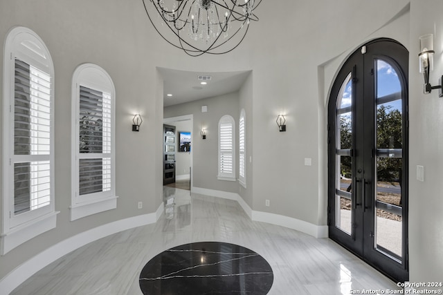 foyer entrance with french doors and a wealth of natural light