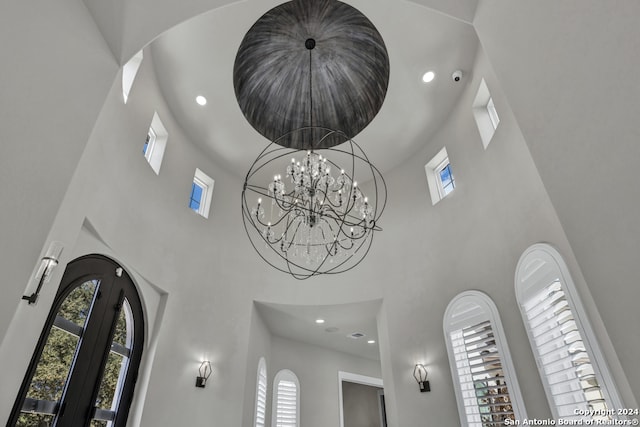 room details featuring french doors and an inviting chandelier